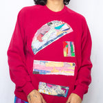 Abstract collage pattern on red sweater by Stella G