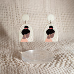 white studio joy earrings withe the image of a woman on them